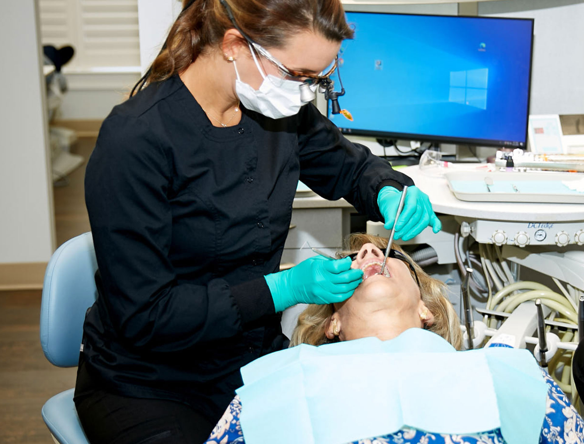 Dr. Price performing dental exam on patient