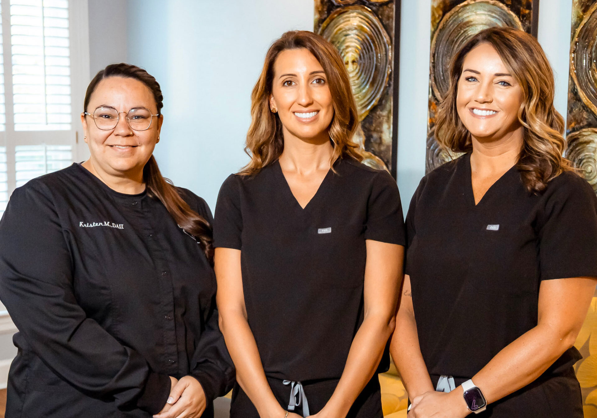 Dr. Price and assistants posing for photo in reception area
